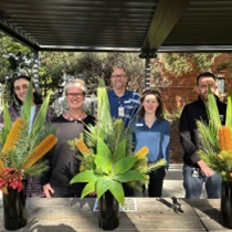 Steven Wells, Garden and Grounds, standing with Austin Health Allied Health team members with beautiful vases of flowers and foliage